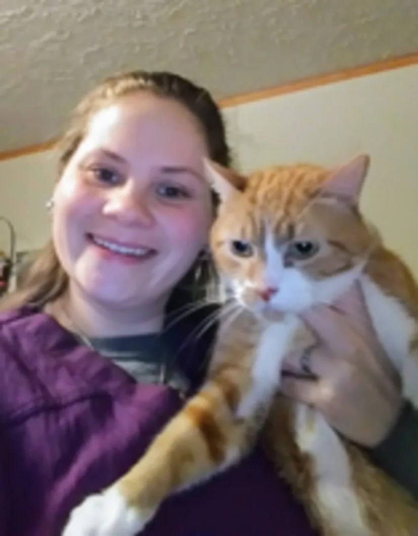 Alicia Harrington holding orange and white cat